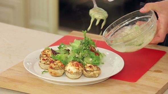 Stuffed Champignon On White Plate With Salad