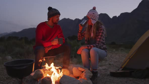 Caucasian couple camping in nature by night