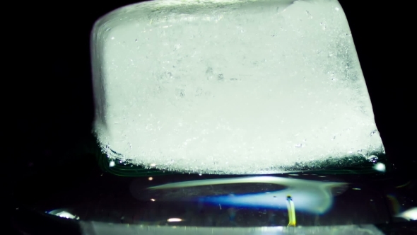 Ice Cube Melting And Moving on a Glass Surface