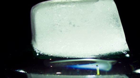 Ice Cube Melting And Moving on a Glass Surface alt