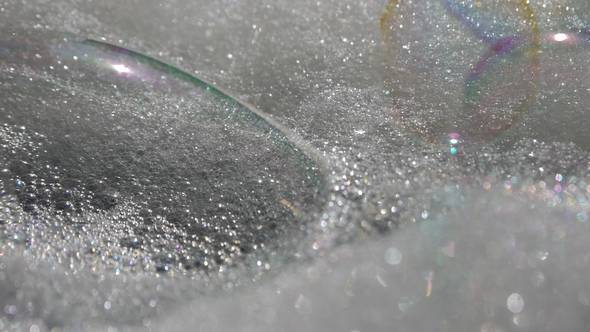 Soap Bubbles Fall on The Foam and Burst