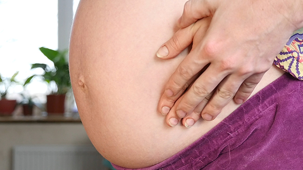 Couple With Hands on Baby Belly alt