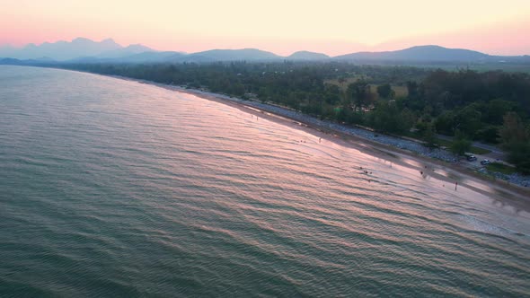 4K Aerial view of drone move on beautiful sea. sunset over ocean waves sand beach.