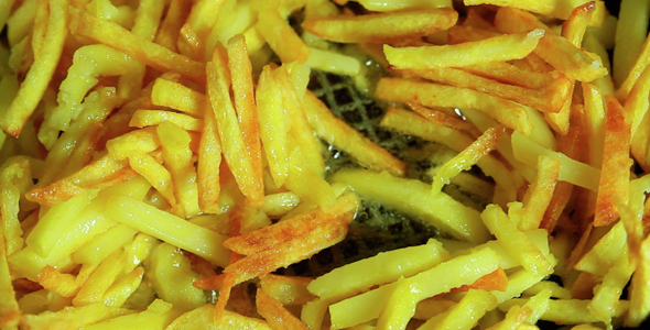 Home Made French Fries. Frying French Fries In Boiling Oil
