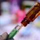 Close up of a syringe with vaccine. Close up of a flask with vaccine.  - VideoHive Item for Sale