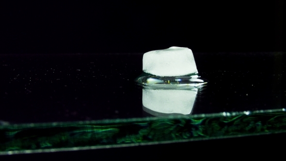 Ice Cube Melting And Moving On a Glass Surface