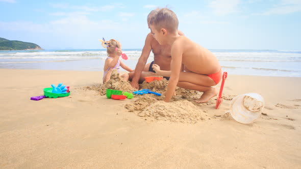 Grandpa Kids Build Sand Castle on Beach by Wave Surf