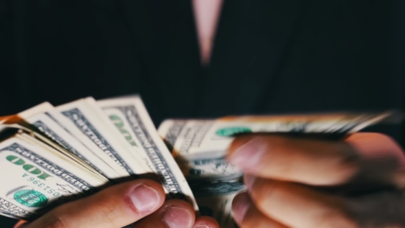 Businessman Counts Money In Hands.