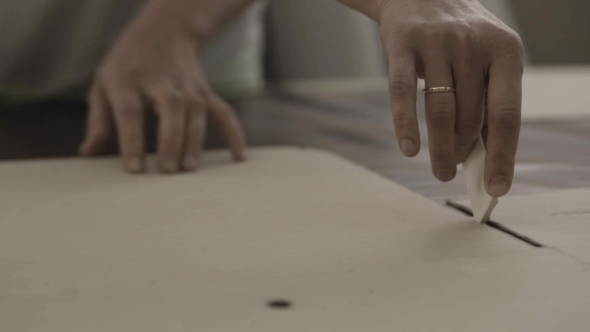 Worker Encircle Cardboard By a Piece Of Chalk In Furniture Factory