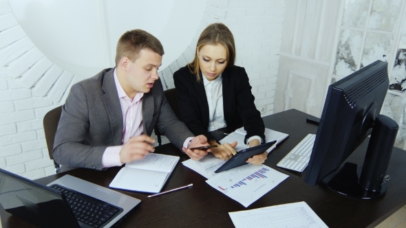 Colleagues Working With a Computer And Other Gadgets alt