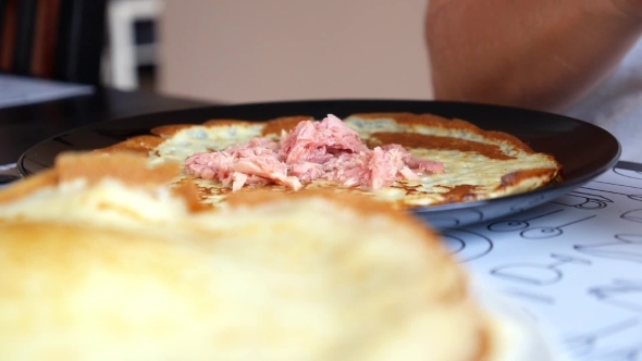 Female Hands Making Pancake Roll With Tuna