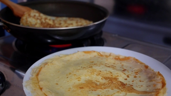 Making Pancake, Crepes On Frying Pan. Closeup.