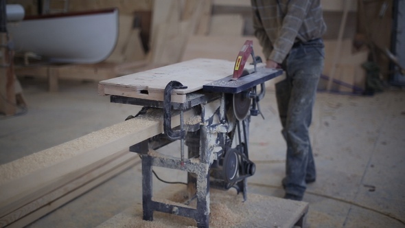 Carpenter Working with Circular Saw Woodworking Machine