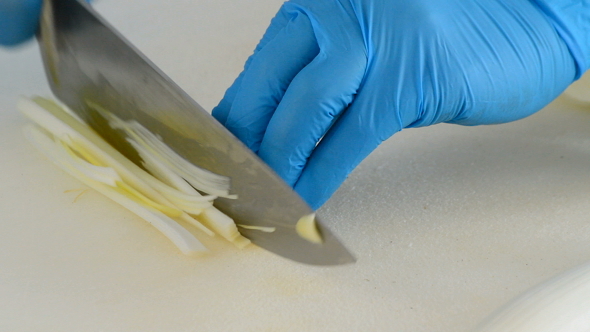 Chef Cutting Vegetable with a Knife