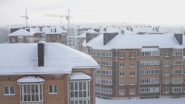 The Smoke From The Chimneys Of a Five-story Residential Home In Winter