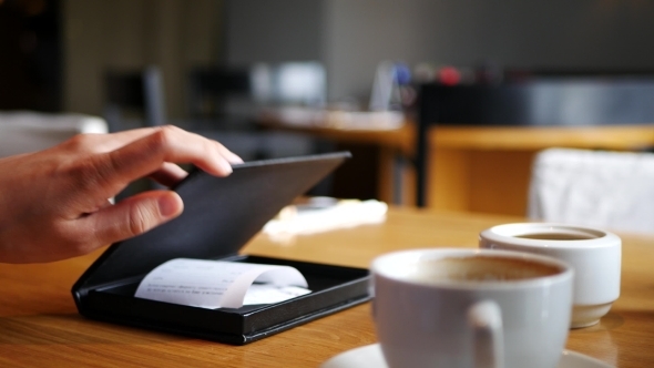 Male Hand Paying Bill In Cafe With Credit Card