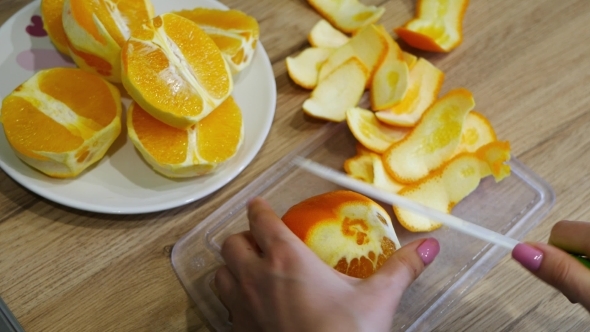 Cutting Fresh Oranges On a Wooden Table