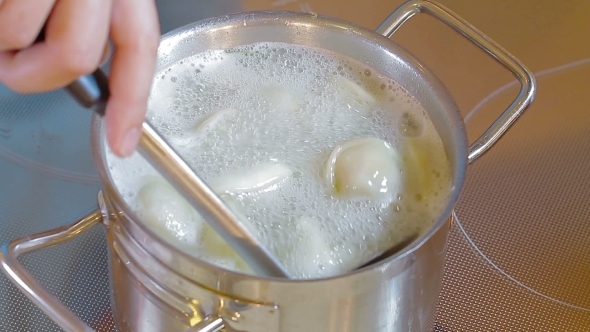 Stirring Spoon Dumplings In The Pan