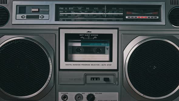 Audio Cassette Tape Rotates in Deck of an Old Tape Recorder