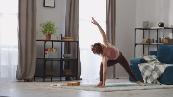 Adult Housewife is Practicing Yoga at Home Performing Asana Caring About Health and Beauty of Body