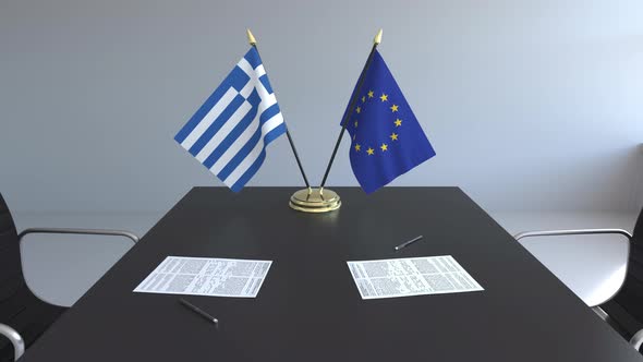 Flags of Greece and the EU and Papers on the Table alt