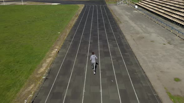 Track runners man boy running on stadium.