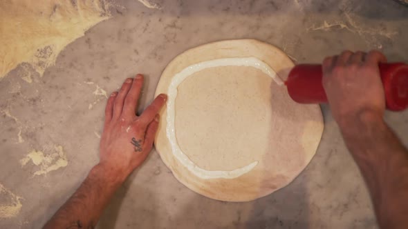 Putting Sweet Sauce on Pizza Dough