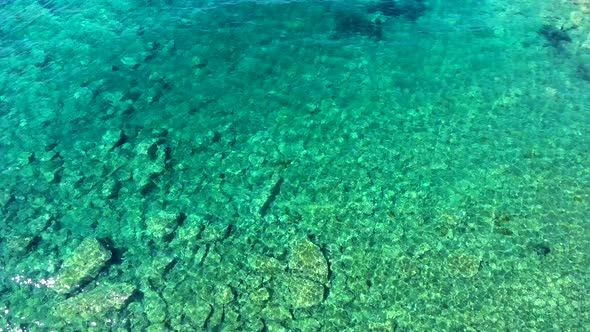 Clear and Shallow Sea Water of the Cove Surrounded by Stone and Rocky Coastline