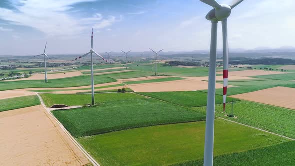 Aerial Flight Near Wind Turbines Energy Production. Clear Renewable Energy Concept