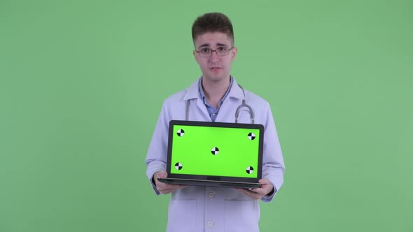 Stressed Young Man Doctor Showing Laptop