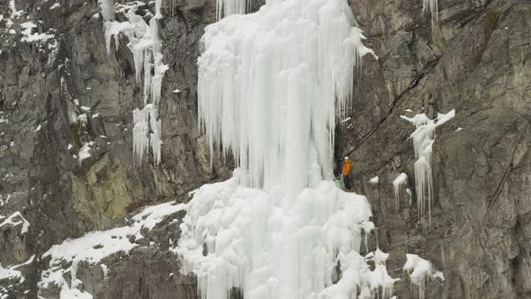 Climber on Sheer frozen cascade off Mount Kineo, Maineline