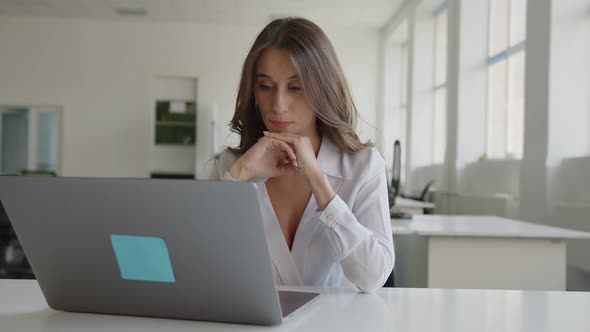 Girl Sits on Her Laptop and Can't Concentrate on Work