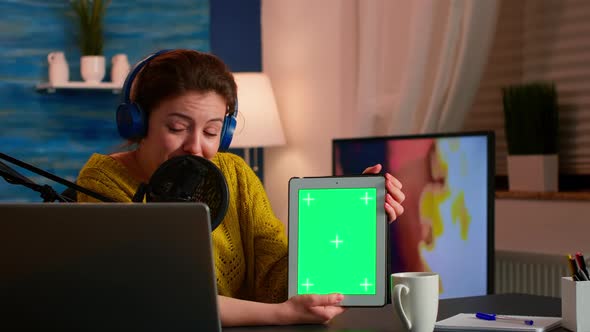 Influencer Holding Tablet with Green Screen Display