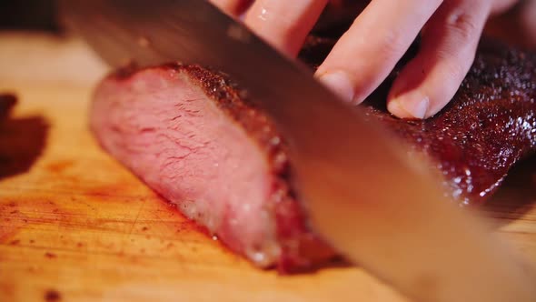 footage of slicing smoked beef close-up