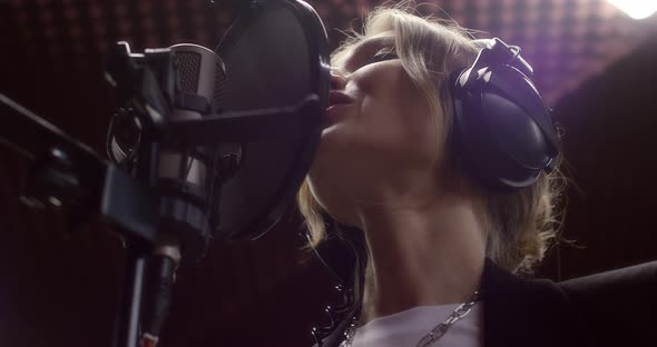 Beautiful Woman Sings a Love Song in Recording Studio