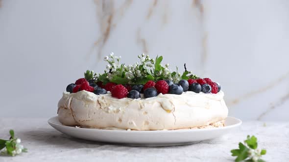 meringue cake with berries on a table
