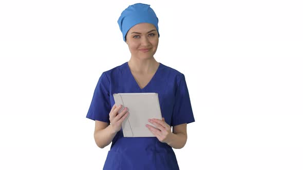 Smiling Female Nurse Using Tablet Computer Walking and Looking at Camera on White Background