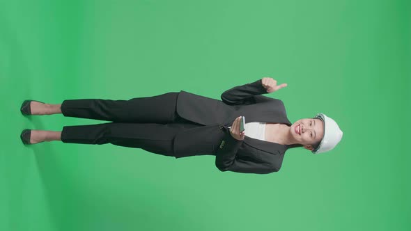 Full Body Of Female Engineer Using Smartphone And Showing Thumbs Up In The Green Screen Studio