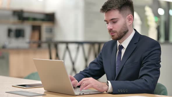 Young Businessman Standing Up and Going Away