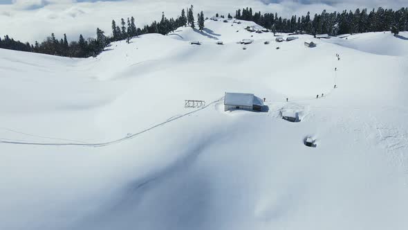 A Group of Ski Touring Enthusiasts Climbs to the Top of a Snowcovered Mountain