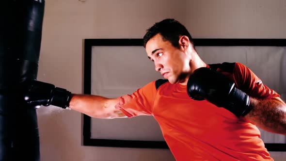 Boxer practicing boxing with punching bag