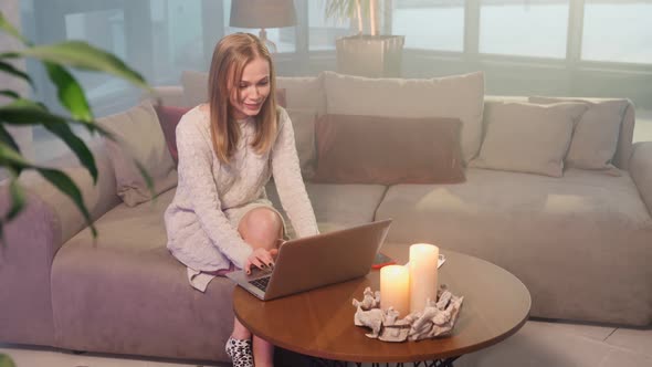 Woman Sitting on Couch and Using Laptop for Video Call