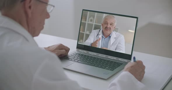 Male Doctor Is Viewing Online Webinar of Professor of Medicine By Laptop, Online Training