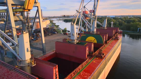 Cargo ship in port with cranes