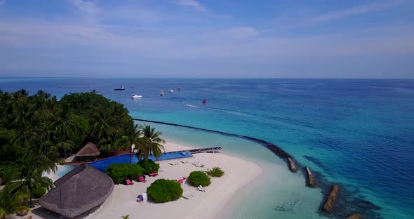 Daytime aerial clean view of a summer white paradise sand beach and aqua blue water background in be