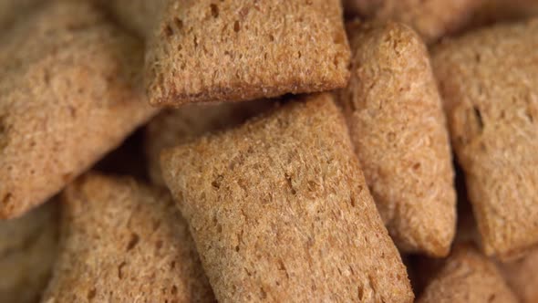 Crispy chocolate pads rotation in macro. Cocoa cereal dessert for a fast breakfast. Morning