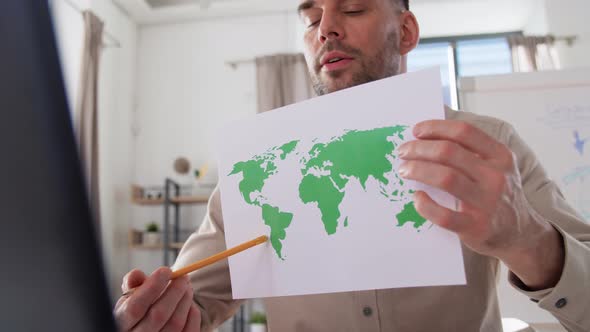 Teacher with World Map Having Online Class at Home