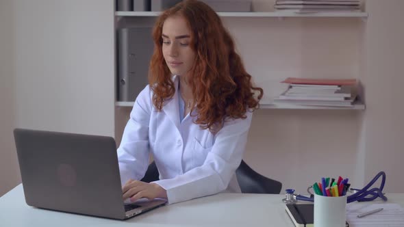 Therapist Work Using Laptop in Office