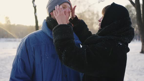 Close Portrait of a Couple in Love in a Winter Snowy Park