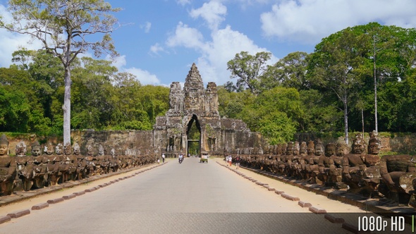 Bayon Angkor Thom Entrance Gate as Tourists Walk and Ride by